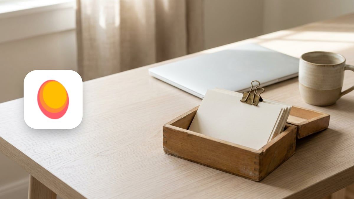 Mangools icon beside a wooden box of index cards with one card clipped, a closed laptop and a cup
