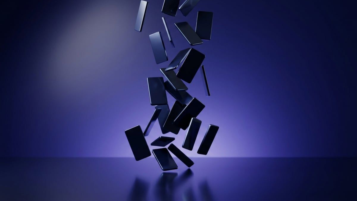 Laptop showing a stock footage library grid with a film strip